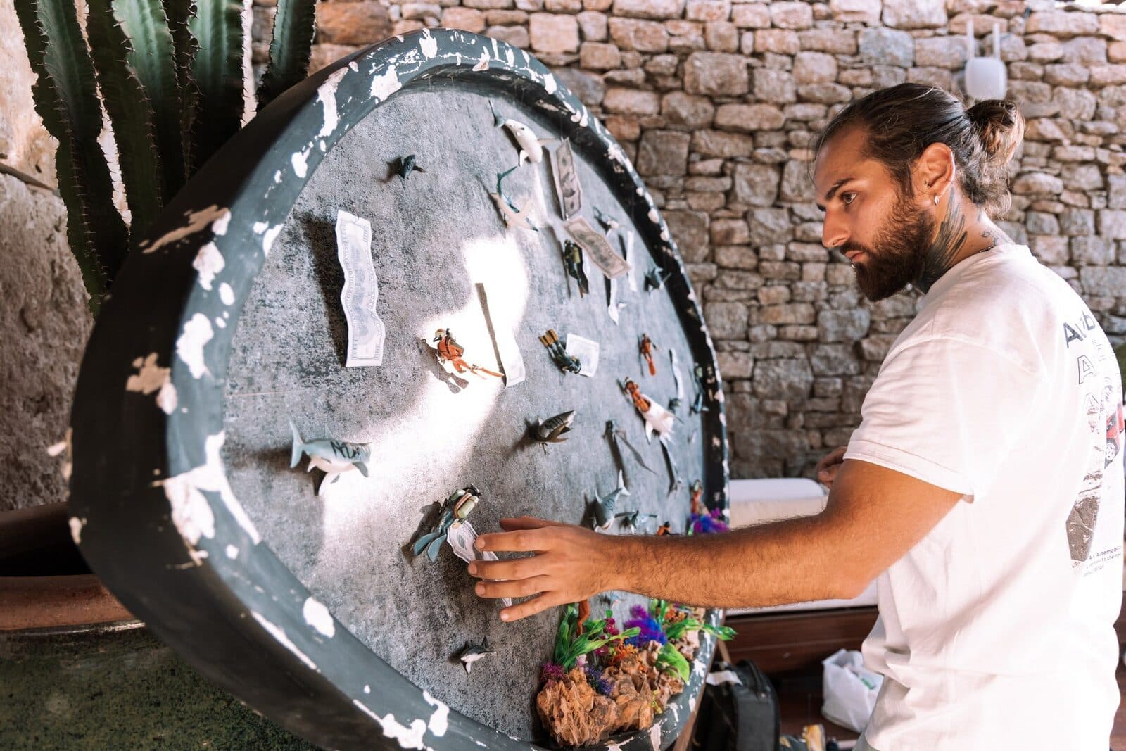 Alia Simetra installing a mixed-media work before the opening