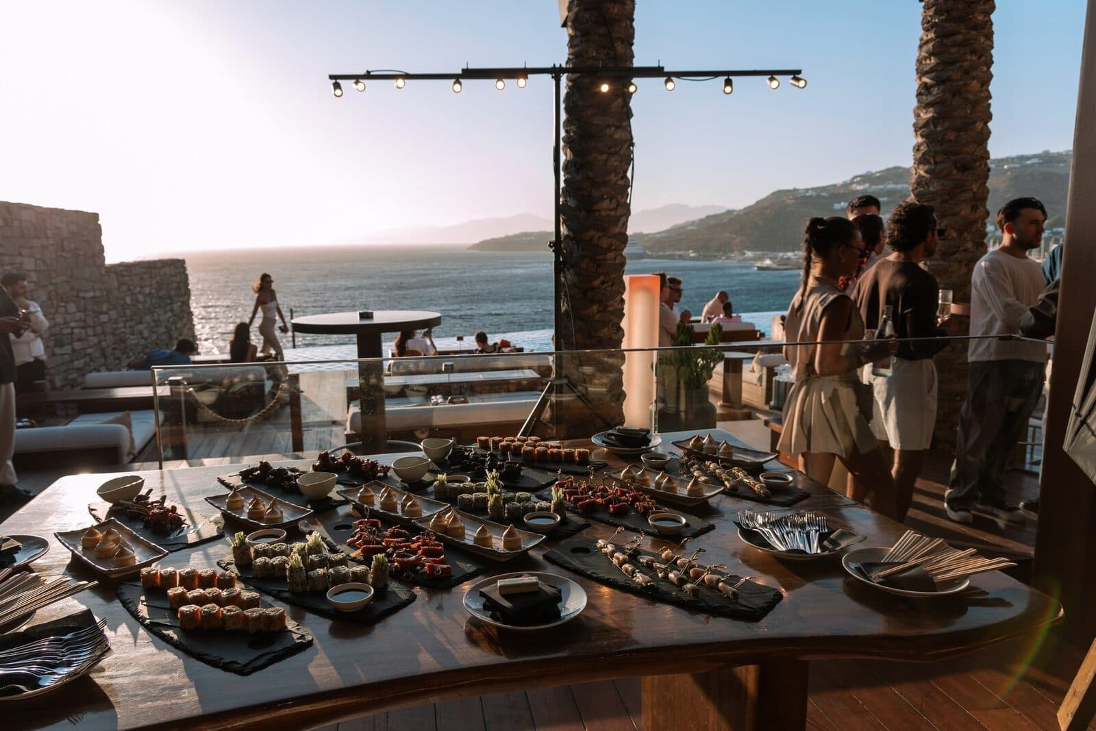 Guests gathering on the terrace at golden hour