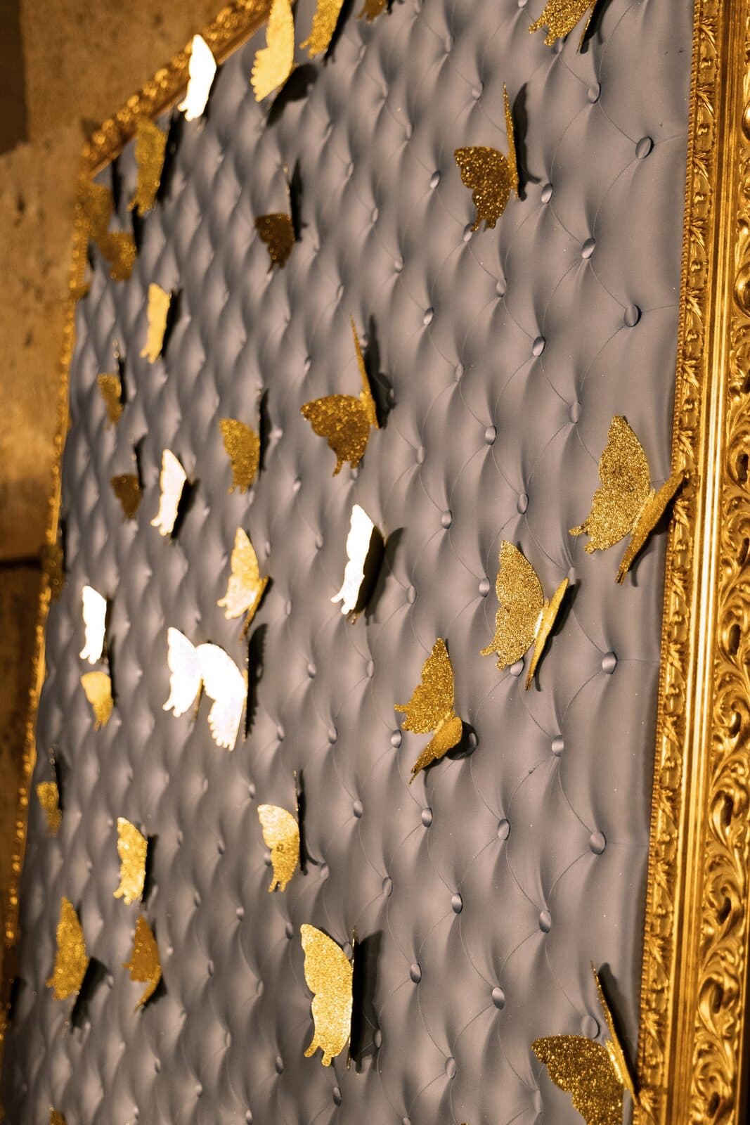 Detail of gilded butterflies on quilted leather